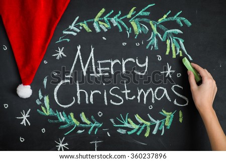 Elegant greeting card design decorated with snowflakes on chalkboard background for Merry Christmas celebration.