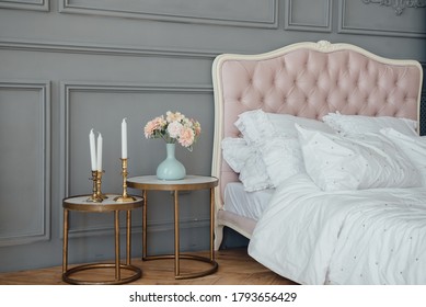 Elegant home or hotel bedroom interior, copy space. Pillows on luxury chesterfield bed, vintage style