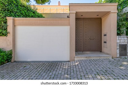 Elegant House Garage And Pedestrian Doors By The Sidewalk