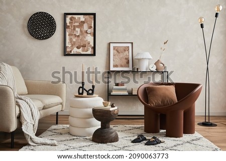 Elegant interior of living room with beige sofa, black console, brown creative armchair, modern lamp, mock up poster frame and stylish home decorations. Copy space. Template.
