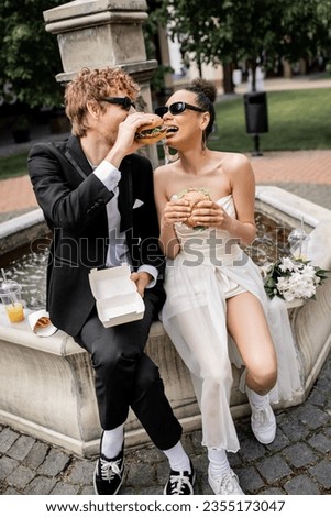 Similar – Image, Stock Photo Happy stylish couple newlyweds in the green forest on summer day. bride in long white dress and groom in red suit are hugging. wedding day