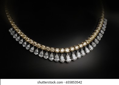 An Elegant Jewelry. Gold And Diamonds Necklace On Black Background.
