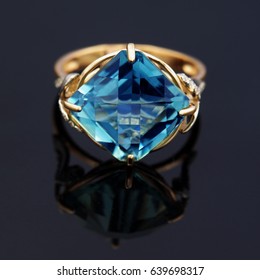 Elegant Jewelry Ring With Blue Topaz Isolated On Black Background