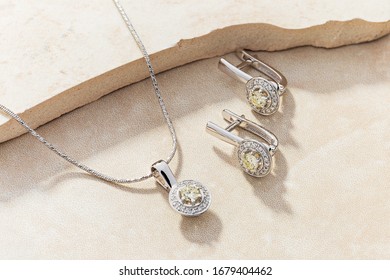 Elegant Jewelry Set Of White Gold Necklace And Earrings With Diamonds. Silver Jewellery Set With Gemstones. Product Still Life Concept