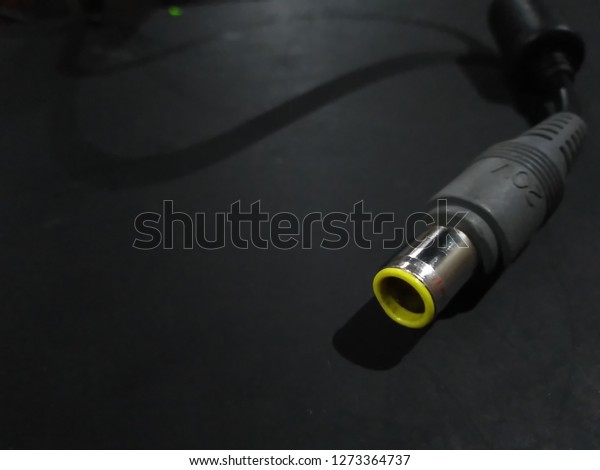 Elegant Laptop Charger On The Black Table\
With Exclusive\
Composition