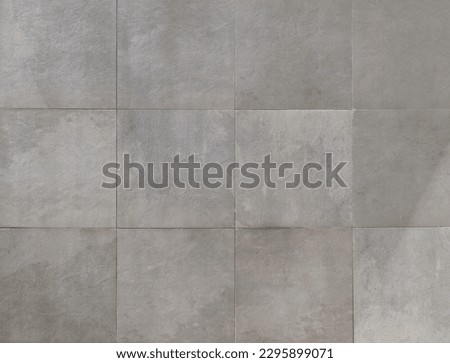 Elegant large gray square stone tiles. Background and texture.