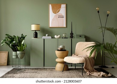 Elegant living room interior design with mockup poster frame, modern frotte armchair, wooden commode and stylish accessories. Green eucalyptus wall. Template. Copy space. - Shutterstock ID 2128003607