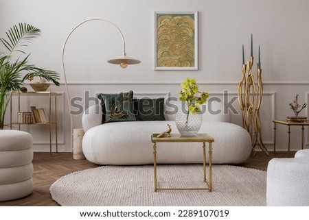 Elegant living room with mock up poster frame, stylish sofa, glass vase with orchid, gold candlestick, green pillows, lamp, round rug, gold coffee table and personal accessories. Home decor. Template.