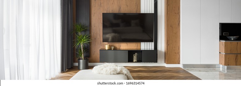 Elegant Living Room With Wooden Wall And Floor And Big Tv Screen, Panorama