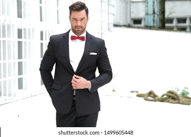 gray suit red bow tie