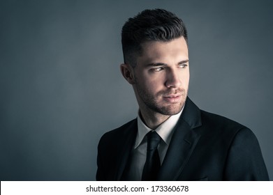 Elegant Man Close Up Portrait Against Dark Background.