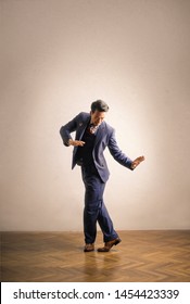 Elegant man dancing on wooden floor