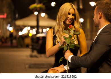 An Elegant Man Giving His Date A Red Rose