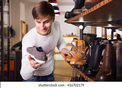 Elegant Man Looking For A Winer Shoes In Store