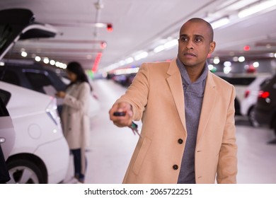 Elegant Man Opens Car With Car Alarm Keychain In Underground Parking