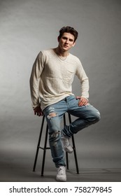 An Elegant Man Sits On A Bar Stool