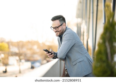 Elegant man with smart phone stock photo texting on phone