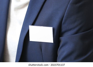Elegant man in suit with blank badge, closeup