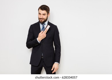 Elegant Man In Suit Standing With His Credit Card, On White Background