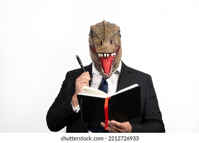 elegant man with a T Rex head making notes in his business diary, on an isolated white background