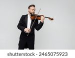 Elegant man violinist on stage performing concert