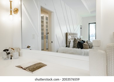 Elegant Master Bedroom And Bathroom With White Furnishings Glass Shower Make Up Counter And Pillows