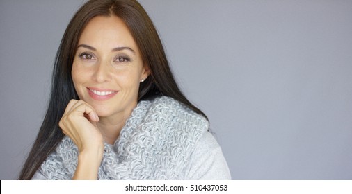 Elegant middle aged woman posing with woolen warm scarf