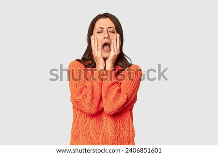 Elegant middle-aged Caucasian woman in studio setting whining and crying disconsolately.