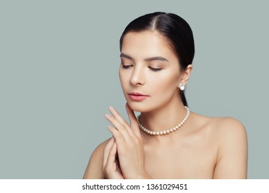 Elegant model woman with clear skin wearing white pearls necklace - Shutterstock ID 1361029451