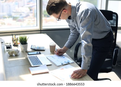 Elegant Modern Businessman Analyzing Data While Working In Office