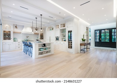 Elegant modern farmhouse interior kitchen dining with bar white marble charcoal grey chairs bar stools and decor - Shutterstock ID 2148631227