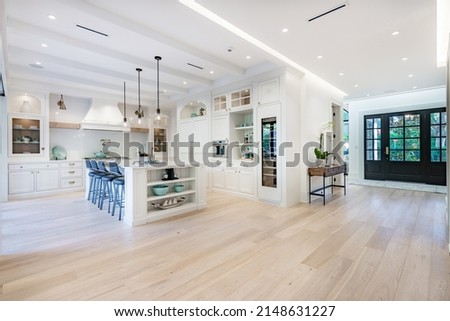 Elegant modern farmhouse interior kitchen dining with bar white marble charcoal grey chairs bar stools and decor Stock foto © 