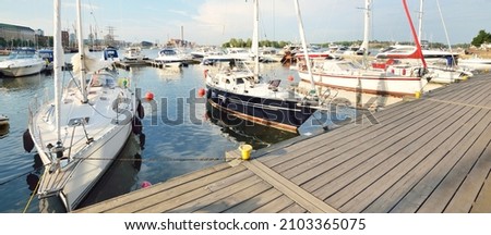 Elegant and modern sailboats and cutters moored to a pier in a central yacht marina in Helsinki, Finland. Summer vacations, cruise, recreation, sport, regatta, leisure activity, service, tourism