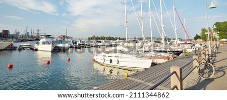 Elegant and modern sailboats and cutters moored to a pier in a central yacht marina in Helsinki, Finland. Summer vacations, cruise, recreation, sport, regatta, leisure activity, service, tourism