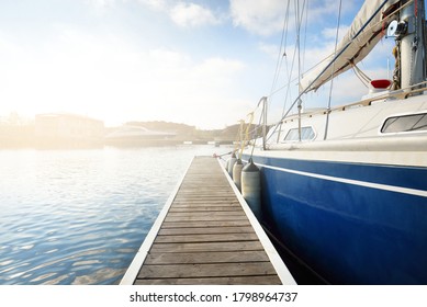 Elegante und moderne Segelboote (zur Miete), die an einem klaren Tag in einem Yachthafen an einen Pier verlegt werden. Schweden. Blaugeschwungene Yacht, Nahaufnahme. Urlaub, Sport, Amateur-Freizeit-Segeln, Kreuzfahrt