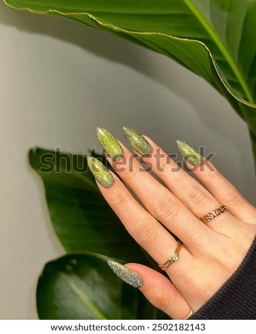Elegant and more artistic Nail art design in young women's hand. Fruit and flowers designs on nails
