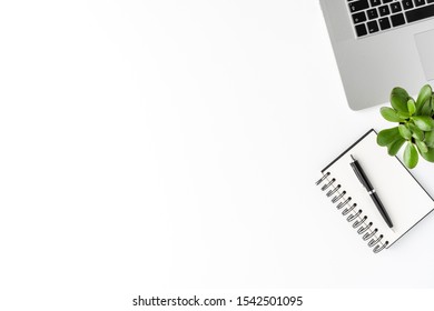 Elegant office desktop with laptop, notebook, pen and small succulent isolated on white background with copyspace. Modern workspace - Shutterstock ID 1542501095