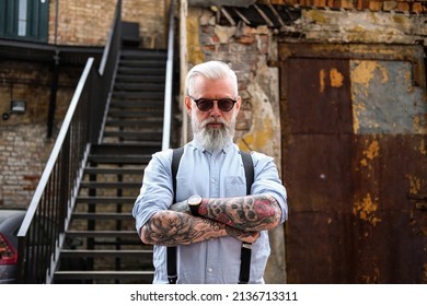 Elegant Old Man Dressed In Shirt And Pants With Suspenders Outdoors