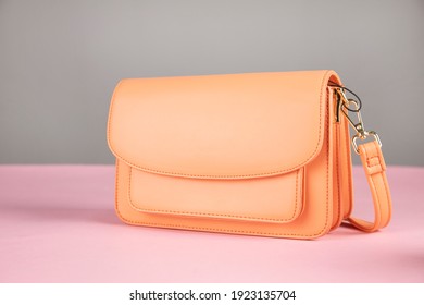 Elegant Orange Handbags On The Table