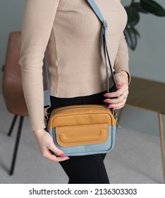 Elegant Outfit. Closeup Of Leather Bag In Hands Of Stylish Woman. Unzipping Bag. Fashionable Girl At Home. Female Fashion. City Lifestyle. Leather Craft