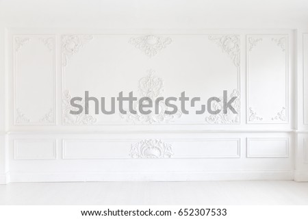 An elegant panel on a white wall made using stucco moldings