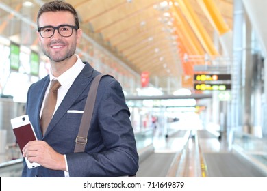 Elegant passenger holding passport and boarding pass at the airport
