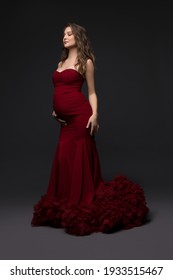 Elegant pregnant woman in dress in studio