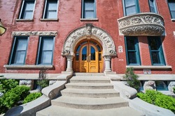 Elegant Red Brick Building Entrance With Arch And Columns