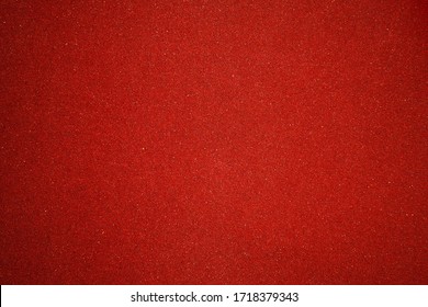 Elegant Red Canvas Background With Vignette And Small Dots. Scarlet Backdrop For Festive Decoration And Internet Design. Texture Of Sandpaper