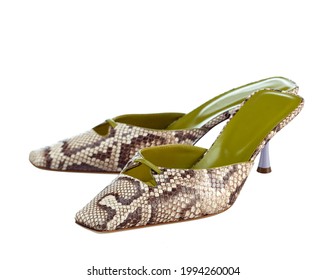 Elegant sandals made of beige crocodile leather, with medium-high heels, isolated on a white background. High quality photo.