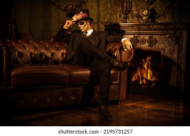 Elegant and scary Baron Samedi in a vintage castle. Handsome man with sugar skull makeup. Dia de los muertos. Day of The Dead. Halloween. Full length portrait.