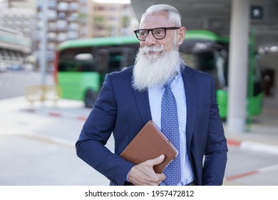 Elegant Senior Business Man Waiting At Bus Station While Holding Digital Tablet