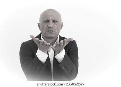 Elegant And Sexy Man Blowing A Kiss, Black And White Photo. A Bald, Handsome Man In A Suit Expresses Love With A Gesture. Love Concept.