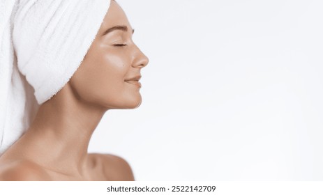 Elegant side profile of a woman with glowing skin, eyes closed, and hair wrapped in a towel, embodying peace and relaxation after a skincare routine. Ideal for beauty, wellness, and spa-related